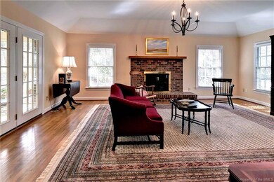 Spacious Family Room, hardwood floors, gas fireplace, access to screened porch.