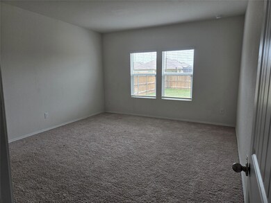 Carpeted empty room with baseboards