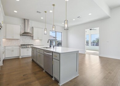 Kitchen featuring visible vents, wall chimney ran