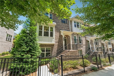 View of front of home with brick siding and a fenced front yard
