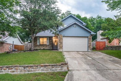 View of front of home with a garage and a front la