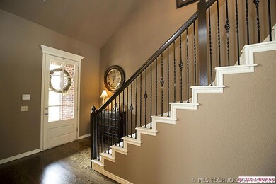 Inviting 2-story Foyer boasts iron spindle stairca