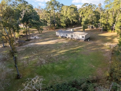 Aerial view of the huge fenced-in backyard provides room for pets, gardening and outdoor activities.