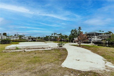 View of community featuring a water view and a lawn