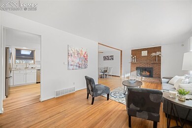 Living room with ceiling fan, sink, light wood-typ