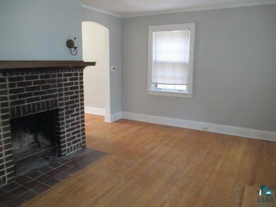 Unfurnished living room with ornamental molding, w