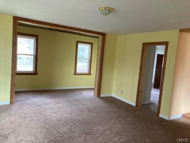 Living room, with nook area, and entry into a firs