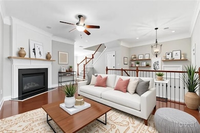 Living room featuring a glass covered fireplace, r