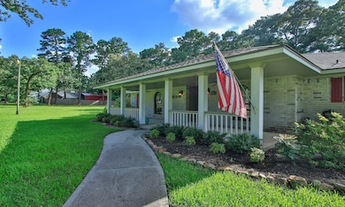This charming home features a welcoming front porch with a landscaped walkway. It boasts a well-maintained lawn, and mature trees. Ideal for those seeking a classic, inviting exterior.