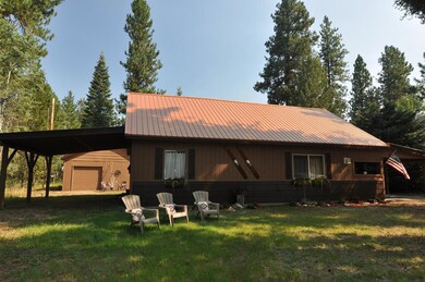 Carport on west side, garage behind house.