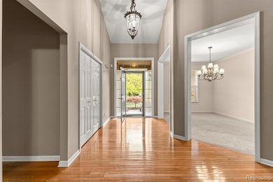 Entryway with a chandelier and light wood-style flooring
