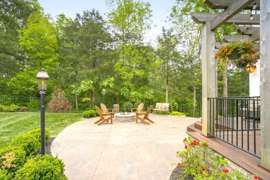 The outdoor space is so special you need to see it first! Through the arched gate and lighted arbor lies an enormous patio and deck made of Brazilian hardwood with a cedar pergola. 2 acres of wooded common space provide ultimate privacy. 