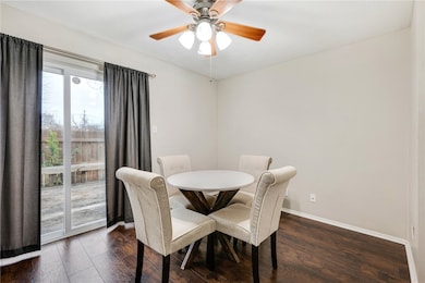 Dining room featuring dark wood-style flooring, ba