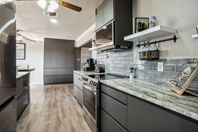 Kitchen with stainless steel electric range, light