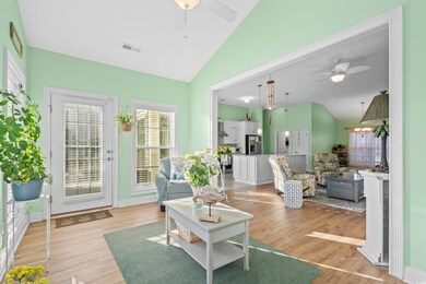 Living room with vaulted ceiling, light hardwood /
