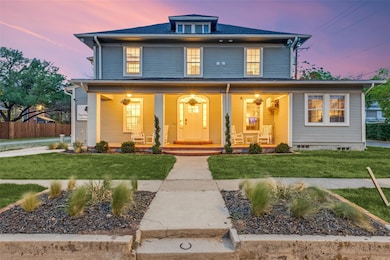 American foursquare style home featuring covered p