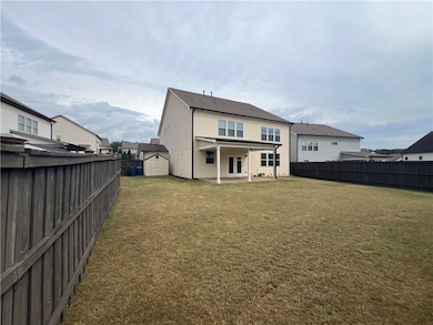 Rear view of house featuring a shed, a patio area, a fenced backyard, and french doors