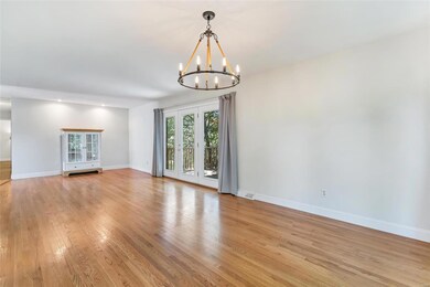 Spacious living area 1 with hardwood and entrance 