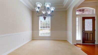 The dining room looks out to the front of the house and has a trey ceiling.