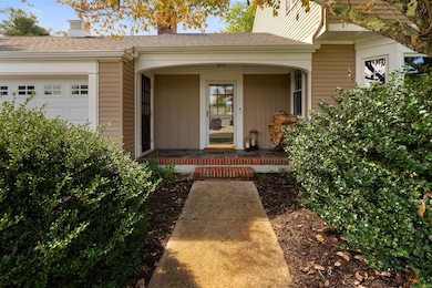 Covered additional entry to garage area and den