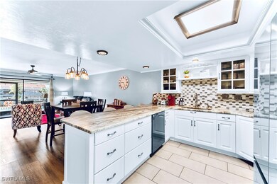 Kitchen with a peninsula, a sink, and glass insert