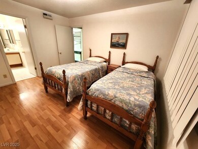 Bedroom featuring light wood-style flooring, ensui