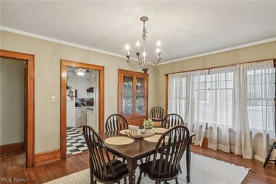 Dining space featuring ornamental molding, dark hardwood / wood-style flooring, and a chandelier