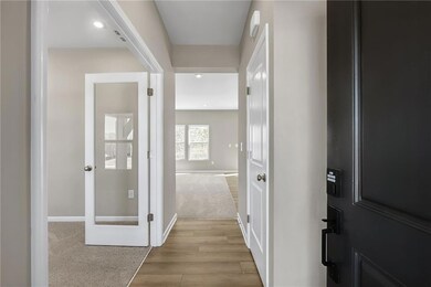 Hallway featuring wood finished floors, baseboards