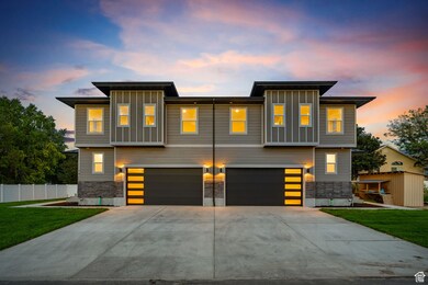 Contemporary house featuring board and batten siding, driveway, and an attached garage