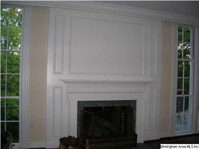 CLOSE-UP OF HANDSOME MILL WORK AT FIREPLACE