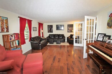 Formal Living Room with Gleaming Floors and Glass 