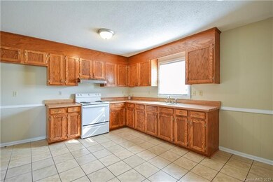 Spacious kitchen with lots of cabinets and natural light.