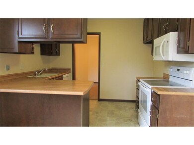 Kitchen offers lots of cabinets, breakfast bar and