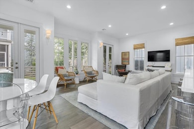 Living area featuring recessed lighting, wood finished floors, and french doors