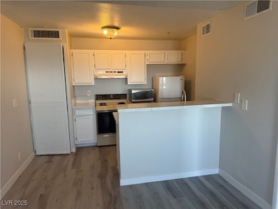 Kitchen featuring stainless steel microwave, range