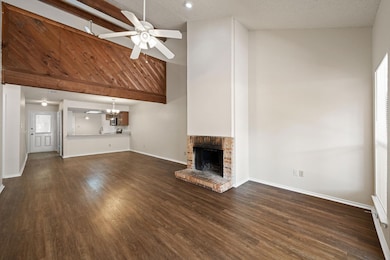Unfurnished living room featuring ceiling fan, a 