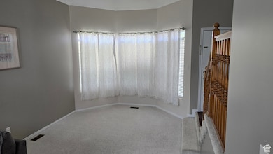 Spare room with carpet floors and plenty of natural light