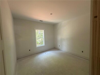 Empty room with finished concrete floors and baseboards