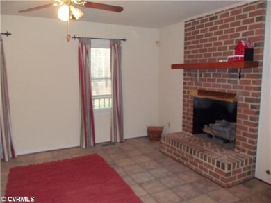 Living Room - Brick fireplace with gas logs