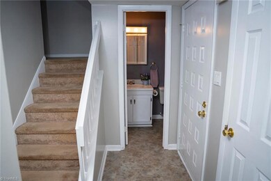 Half Bath Off Foyer And Next To Front Door At Right; At Left Is Stairs To Second Floor