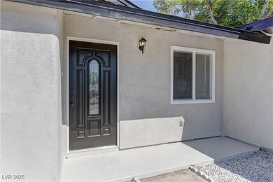 View of exterior entry featuring stucco siding