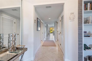 Hall featuring light tile patterned floors and a b