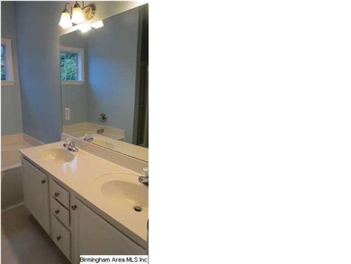 Master bath features dual sinks, jetted garden tub