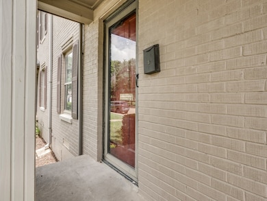 Entrance to property featuring brick siding