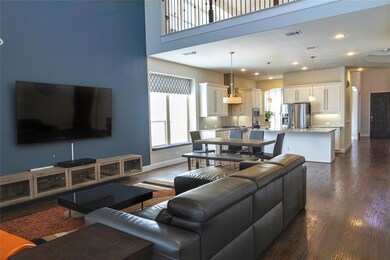 Living room with a high ceiling and dark wood-type flooring