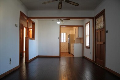 Dinig area right off kitchen with ceiling fan and hardwood flors