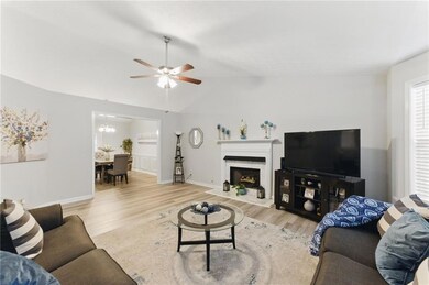 Living room featuring lofted ceiling, wood finishe