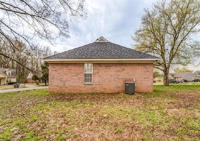 View of side of property featuring central AC and a shingled roof