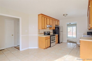 Kitchen with backsplash, under cabinet range hood,