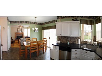 Eat-in kitchen with granite coat counters and tile